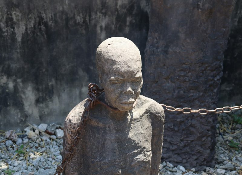 Once upon a time, Nigerians lived in relative cultural harmony, engaged in trade, farming, craftsmanship, governance, and rich oral traditions. Then came the horrors of human exploitation: first through the trans-Saharan slave trade and later, the brutal trans-Atlantic slave trade. Over roughly 14 centuries, Africa, Nigeria in particular, suffered a sustained, systematic dismantling of its communities, cultures, and psychological fabric. This extensive period is more than sufficient to leave profound scars. The trans-Atlantic slave trade was not merely an economic enterprise. It was a cultural holocaust, a moral implosion that still echoes today. One of the most harrowing illustrations of Nigeria’s involvement is the story of the Igbo Landing, a tale of both tragedy and resilience. The Igbo Landing: A Symbol of Defiance This historical event recounts the journey of enslaved Igbo people taken through the infamous Middle Passage, where they endured unspeakable atrocities, malnutrition, overcrowding, disease, and death aboard slave ships bound for the Americas. However, during one such journey in 1803, a group of Igbo captives rose in defiance. Upon arrival at Dunbar Creek in Georgia, USA, they overpowered their captors and, rather than submit to slavery, marched into the water, chanting and singing, and chose death over bondage. This act of collective resistance became a poignant symbol of dignity and the unyielding African spirit. Two Centuries Later: Are We Still Affected? Despite the passage of over two hundred years, many scholars, psychologists, and cultural theorists argue that the trauma of slavery still reverberates through African societies. This hypothesis, while debated, is encapsulated in the concept of Post-Traumatic Slave Syndrome (PTSS), a theory proposed by American clinical psychologist Dr. Joy DeGruy. What is Post-Traumatic Slave Syndrome (PTSS)? Dr. DeGruy’s groundbreaking work, Post-Traumatic Slave Syndrome: America's Legacy of Enduring Injury and Healing, explores the idea that the dehumanisation experienced during slavery has left psychological wounds that have been inherited across generations. Drawing from years of clinical research, she posits that the collective trauma endured by African slaves, including Nigerians, has not been properly healed and has instead morphed into patterns of behaviour that persist within black communities. Her theory addresses both the legacy of the Atlantic slave trade and its enduring psychological footprint on African descendants. According to Dr. DeGruy, many of the coping mechanisms adopted under slavery have become intergenerational habits, some of them harmful. Symptoms and Behavioural Patterns Attributed to PTSS While PTSS remains a contentious theory in academic circles, it has been identified with several behavioural traits believed to reflect unresolved historical trauma: Heightened Anger and Violence: Individuals affected may exhibit disproportionate levels of anger, suspicion, and, in some cases, violence, both directed outward and inward. This, Dr. DeGruy suggests, stems from a centuries-old environment of brutality and suppression. Low Self-Esteem and Identity Crisis: Feelings of inadequacy, shame, and self-hate are common, including a deep-seated aversion to African features, customs, and languages. This disconnection from one’s roots is believed to originate from the enforced rejection of identity during slavery. Aversion to Cultural Heritage: Some black individuals show discomfort with or rejection of their cultural backgrounds, often seeking validation from Eurocentric norms. This phenomenon, as argued in the book, may be a residual response to centuries of cultural invalidation. Criticism of the Theory It is important to acknowledge the opposition. Many scholars argue that PTSS dangerously overgeneralises and risks painting black people as inherently broken or pathologically damaged. After all, traits such as anger, poor parenting, and violence are not unique to black people; they are found across all races and cultures. Critics also argue that attributing widespread behavioural issues solely to slavery oversimplifies complex socio-economic and cultural realities. For instance, poor parenting exists globally and cannot be uniquely tied to slavery without rigorous scientific backing. Nonetheless, even among sceptics, there’s an emerging consensus: slavery did immense psychological and societal damage, the full impact of which has not been adequately addressed or healed. How Does This Affect Nigerians Today? The psychological legacy of slavery may not be visible in the form of physical chains, but it could be embedded in our institutions, relationships, and self-perception. In Nigeria, this might be seen in several ways: Tribal mistrust and disunity, partly rooted in the era when tribes were pitted against each other, often selling fellow Africans to foreign traders. Colonial hangover, where Western standards are often prioritised over indigenous knowledge systems and traditions. A fractured sense of identity, with many Nigerians struggling to reconcile cultural heritage with imposed foreign ideals. There is also the challenge of internalised inferiority, where “foreign” is still often perceived as better, be it accents, education, fashion, or even beauty standards. This deep psychological rift can be traced to centuries of cultural suppression and displacement. Epigenetics and Inherited Trauma Recent studies in epigenetics (the study of how behaviour and environment affect the way our genes work) have lent some support to theories of inherited trauma. Survivors of the Holocaust, for instance, have reportedly passed genetic markers of trauma to subsequent generations. If trauma can be biologically inherited, then the African experience with slavery could indeed have generational consequences. What Can We Do About It? Healing from historical trauma is not just about remembering the past—it’s about transforming it. For Nigeria to fully emerge from the shadow of slavery, we must: Reclaim our narrative. Nigerian history should not begin with colonialism or slavery. We must teach and celebrate our pre-slavery civilisations, Nok, Ife, Benin, Kanem-Bornu, and more. Revive indigenous languages and culture. Language is power. Culture is identity. Embracing them is a form of resistance and healing. Foster national unity. Slavery and colonialism divided us; our future depends on working together across tribal, religious, and regional lines. Promote mental health literacy. Let’s normalise seeking psychological help and destigmatise mental health challenges, particularly those rooted in intergenerational trauma. Conclusion: Rising from the Ashes Slavery was a horrific chapter in our history, marked by loss, degradation, and dehumanisation. But it is not the end of our story. As Nigerians, we carry the resilience of our ancestors in our blood. Though broken, we are not beyond repair. We can rise. We can reclaim our dignity, culture, and strength. We can re-educate ourselves, heal our divisions, and reject the falsehoods of inferiority. Let us not remain captives of the past but architects of a future where our scars become symbols of survival, not shackles of sorrow. In unity, in truth, and in pride, Nigeria can heal and flourish again.